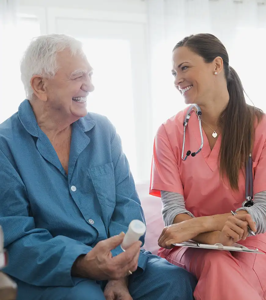 Nurse listening to an older adult during a home visit.